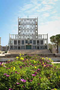 View of flowering plants in front of building