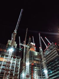 Low angle view of illuminated skyscrapers against sky at night