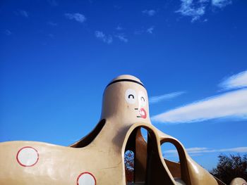 Low angle view of sculpture against blue sky