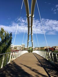 Footbridge against blue sky