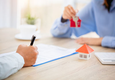 Midsection of woman holding gift on table