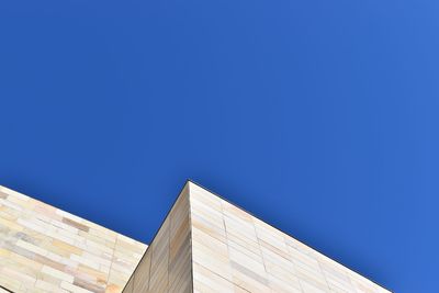 Low angle view of building against clear blue sky