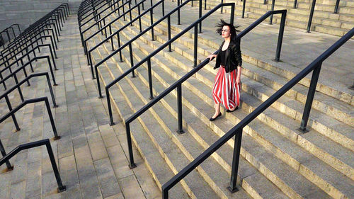 Full length of woman moving down on steps