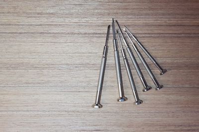 High angle view of nails on wooden table
