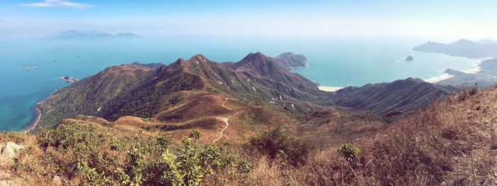 Scenic view of sea and mountains against sky