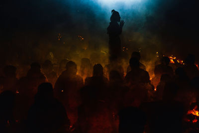 Silhouette people praying in temple