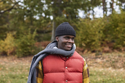 Smiling young man in knit hat and scarf