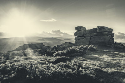 Rock tor on moorland against sky