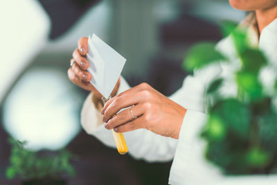 Close-up of woman holding test tube