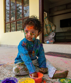 Portrait of cute boy sitting at home