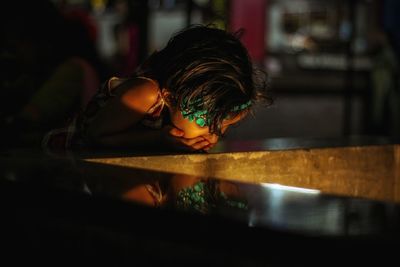 Girl looking at illuminated table