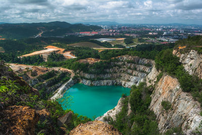 High angle view of river amidst city against sky