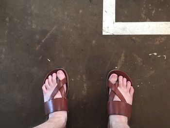 Low section of woman standing on tiled floor