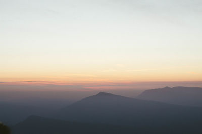 Scenic view of silhouette mountains against sky during sunset