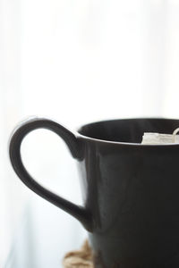 Close-up of coffee cup against white background