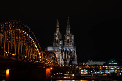 Illuminated buildings against sky at night