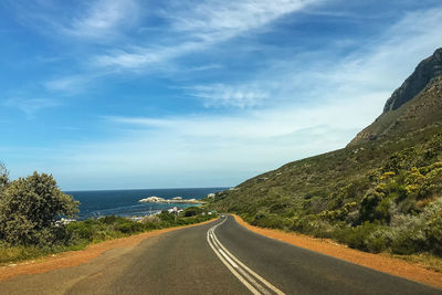 Road by sea against sky