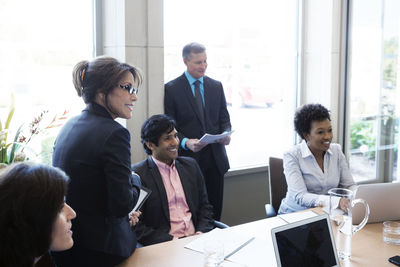 Happy business people discussing in office