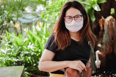 Portrait of beautiful young woman with mask