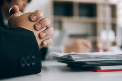 Close-up of woman hand on table