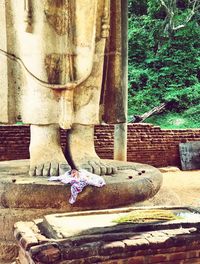 Statue of buddha against trees