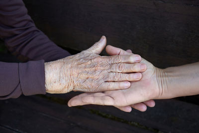 High angle view of hand holding hands