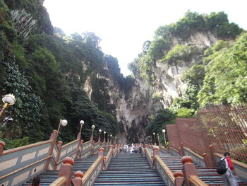 People on staircase against sky