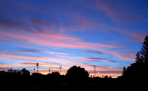 Silhouette of trees against sky at sunset