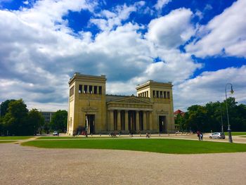 Facade of historic building against cloudy sky