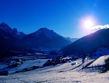 Scenic view of snow covered mountains against sky