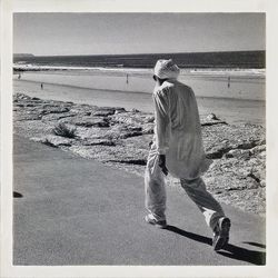 People walking on beach against clear sky