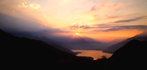 Scenic view of silhouette mountains against sky during sunset