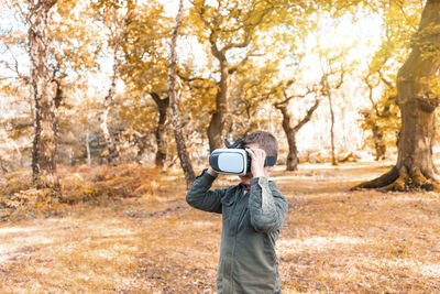 Man photographing in forest