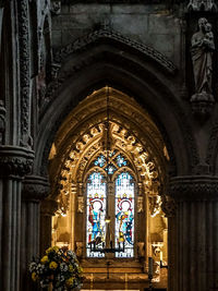 Stained glass window seen from archway at rosslyn chapel