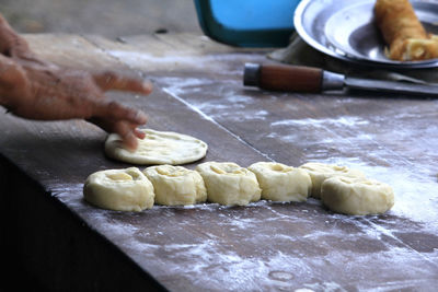 Cropped image of person preparing food at table