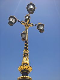 Low angle view of antique street light against clear sky