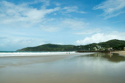 Scenic view of sea against cloudy sky