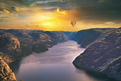 View over lysefjord ,norway with dramatic skies and captive balloon over mountain range