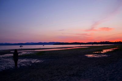 View of calm beach at sunset