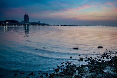 Scenic view of sea against sky at dusk