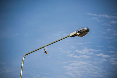 Low angle view of street light against sky