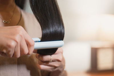 Midsection of woman using mobile phone