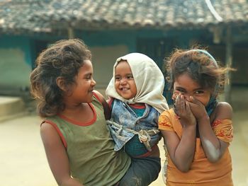 Siblings and daughter outdoors