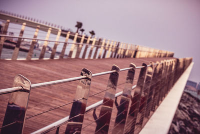 Close-up of railing against clear sky