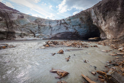 Glacial stream that enters a cave carved into the vallelunga glacier ice, italy