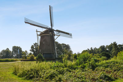 Low angle view of windmill against clear sky