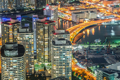 High angle view of city lit up at night