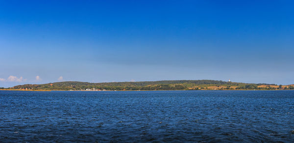 Scenic view of sea against clear blue sky