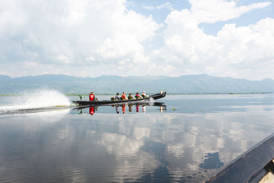 People on boat against sky