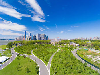 View of cityscape against cloudy sky